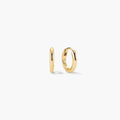 Gold-tone tube huggie hoop earrings, angled view
