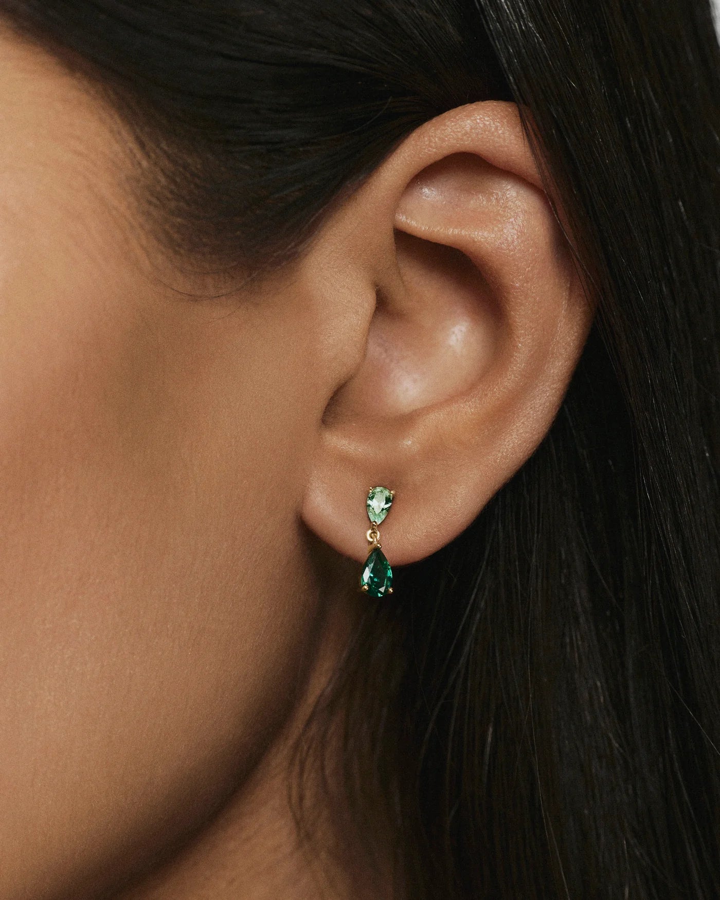 Ada green stone drop earrings worn on the ear
