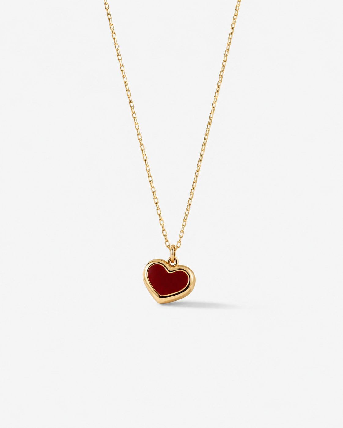 Red heart pendant on a fine gold-tone chain necklace